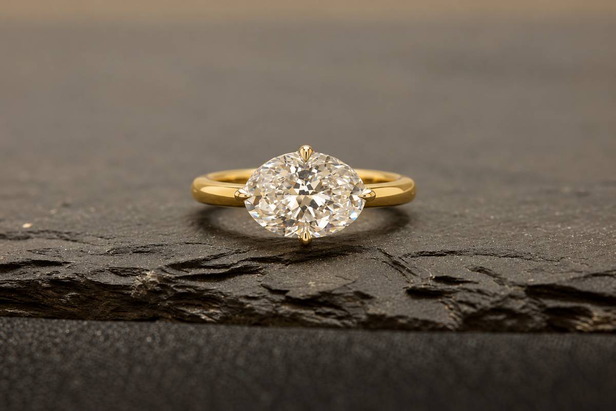 Oval diamond engagement ring on a dark slate surface