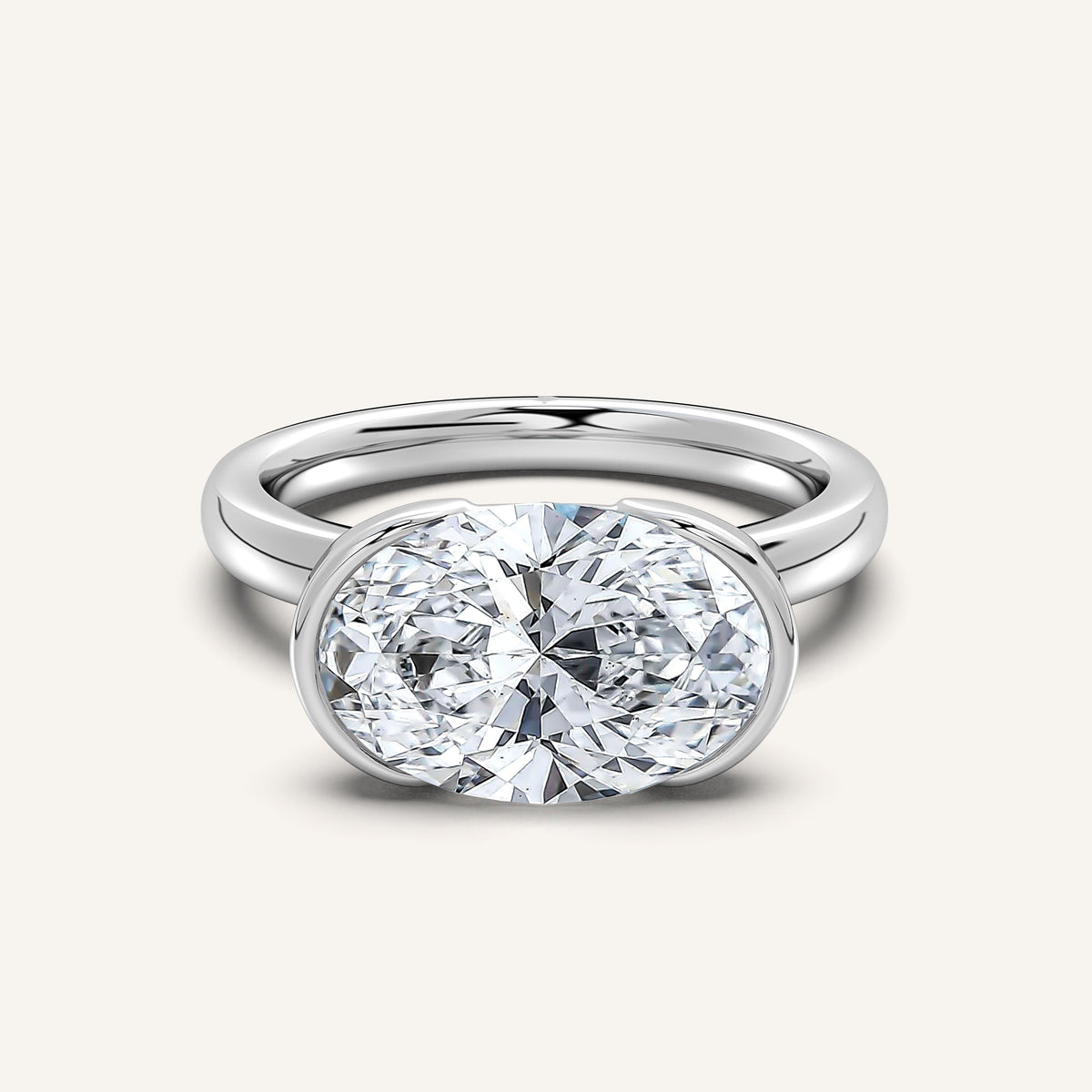 Oval east-west half bezel engagement ring in 14k white gold, the lab-grown diamond set across the finger