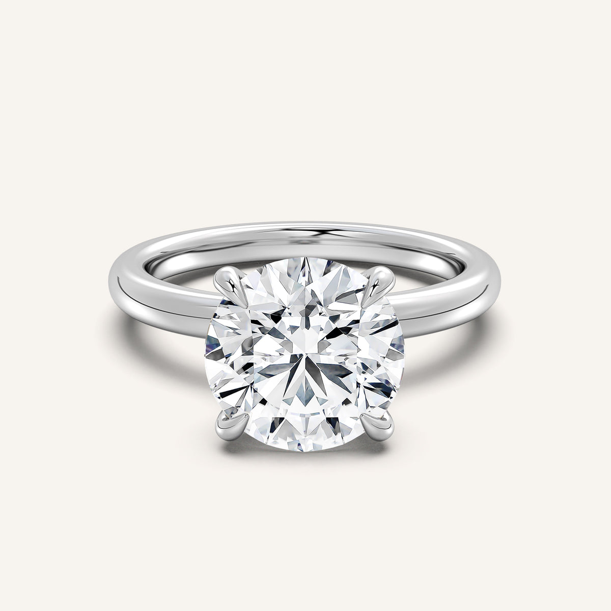 Round brilliant solitaire engagement ring in 14k white gold, a lab-grown round diamond held by four claw prongs