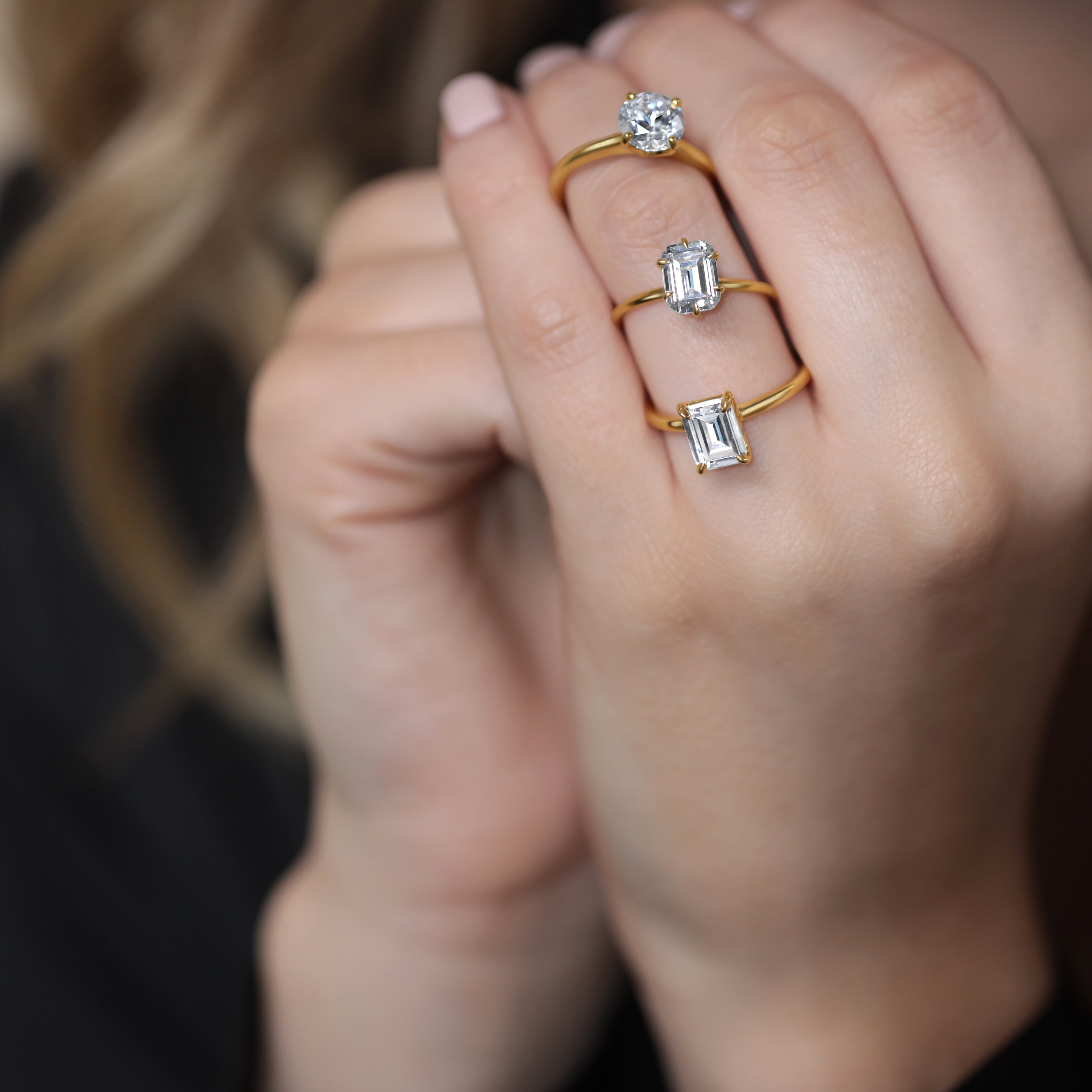 Elegant lab-grown diamond rings in gold, featuring round and emerald cuts for ethical engagement.