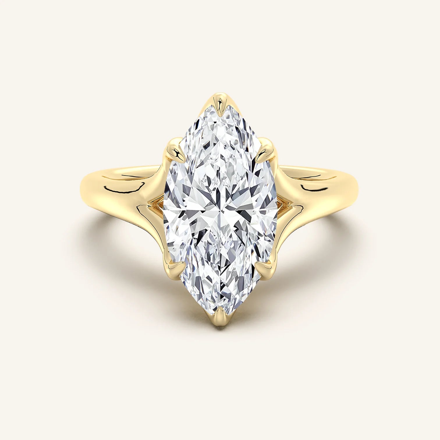Gold ring with a large diamond on a light beige background