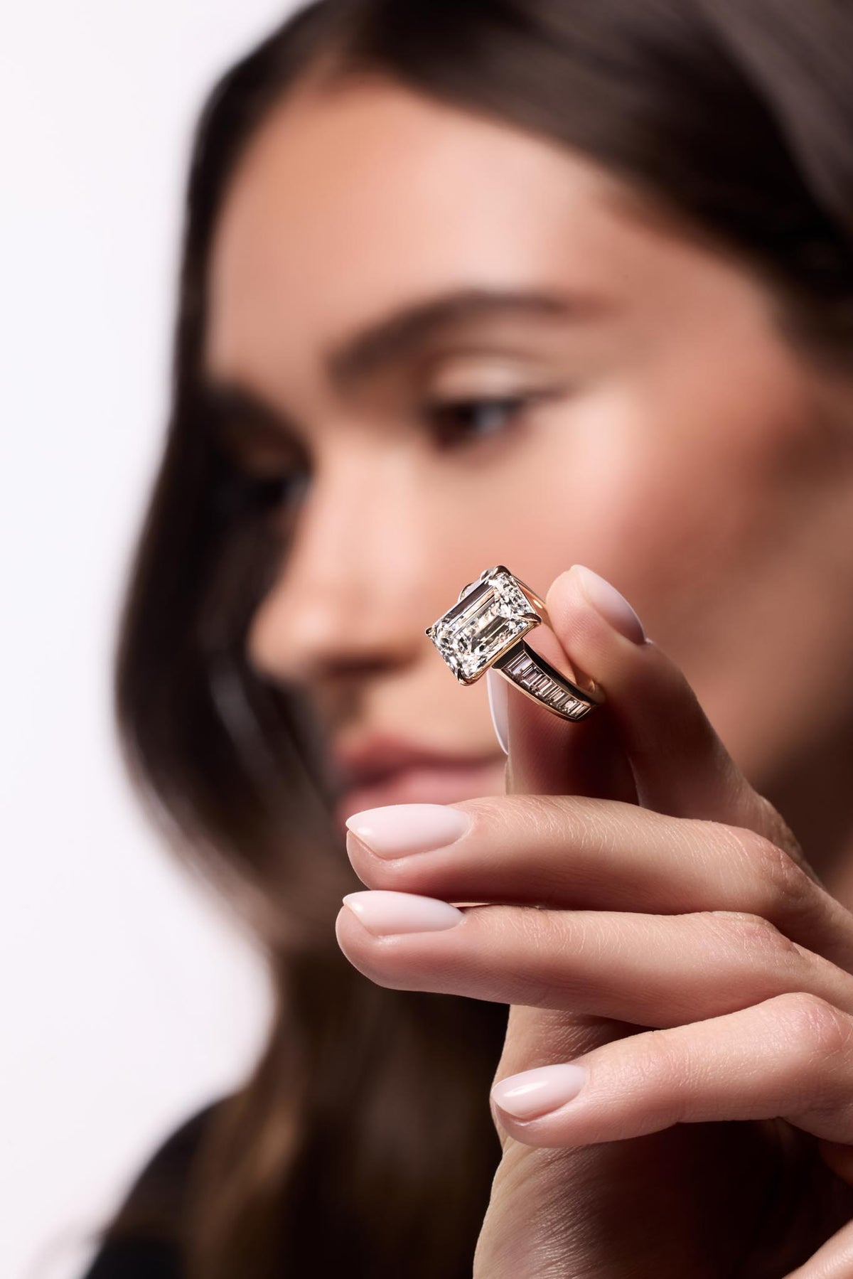 Emerald-cut diamond ring with a baguette band, worn