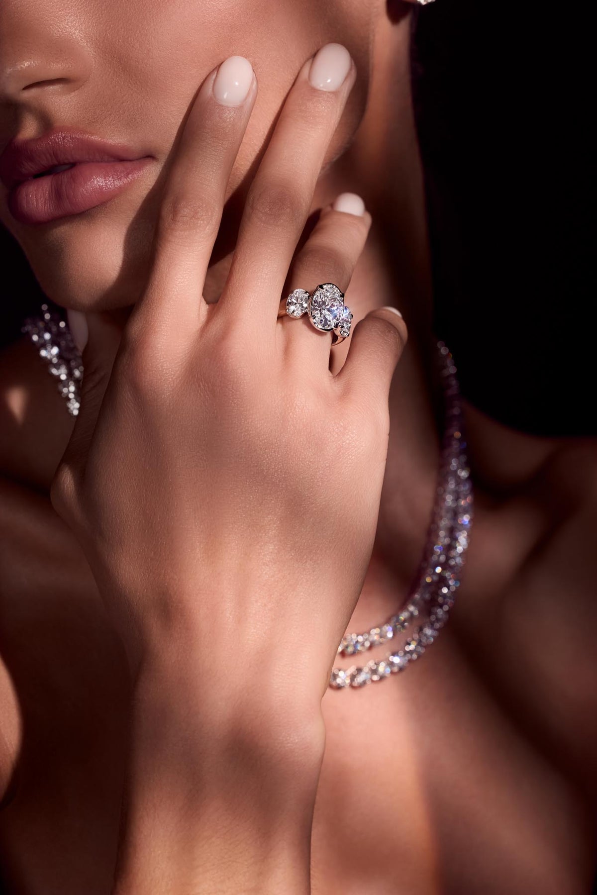 Diamond tennis bracelets and a diamond ring, worn