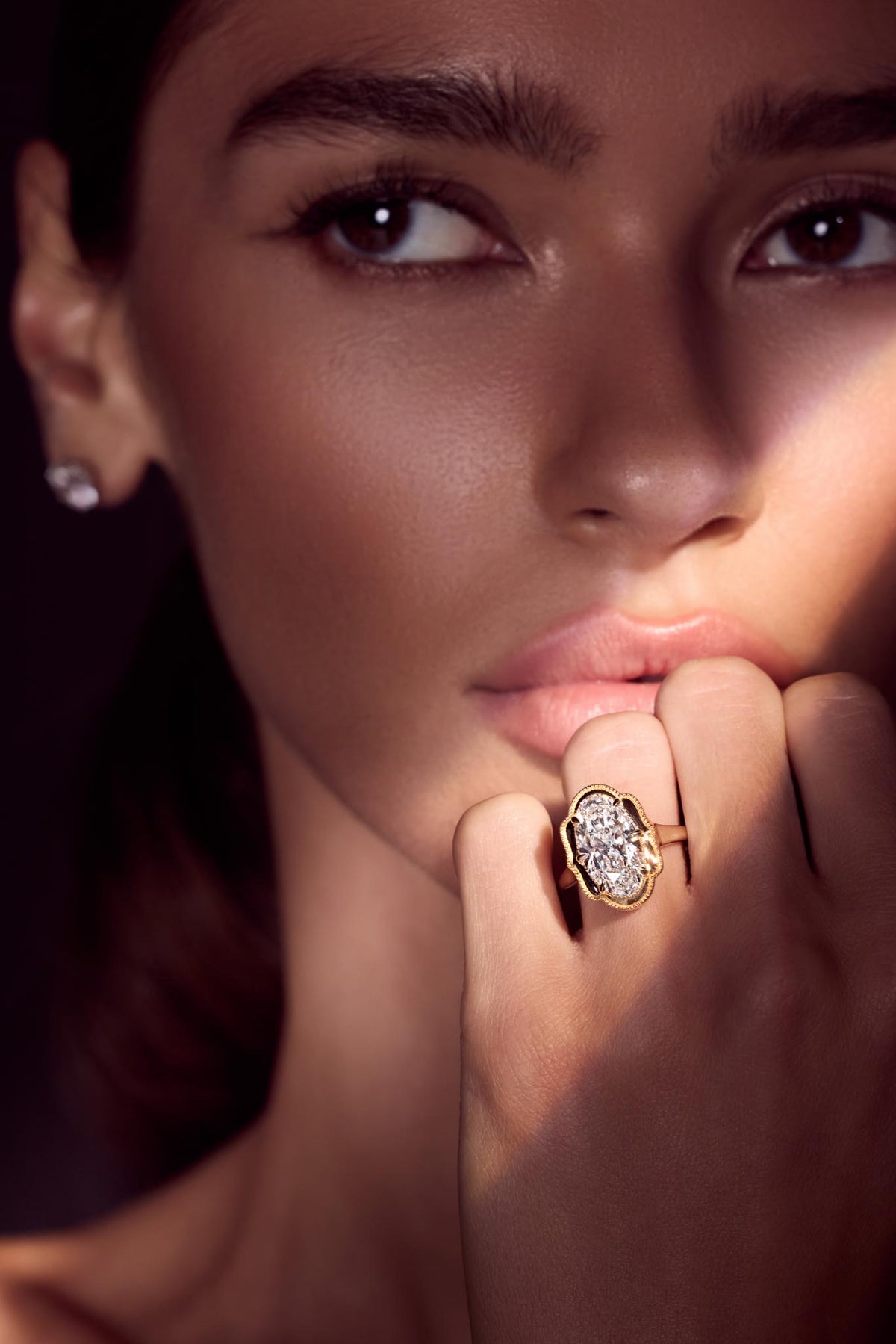 Round diamond stud earring, worn