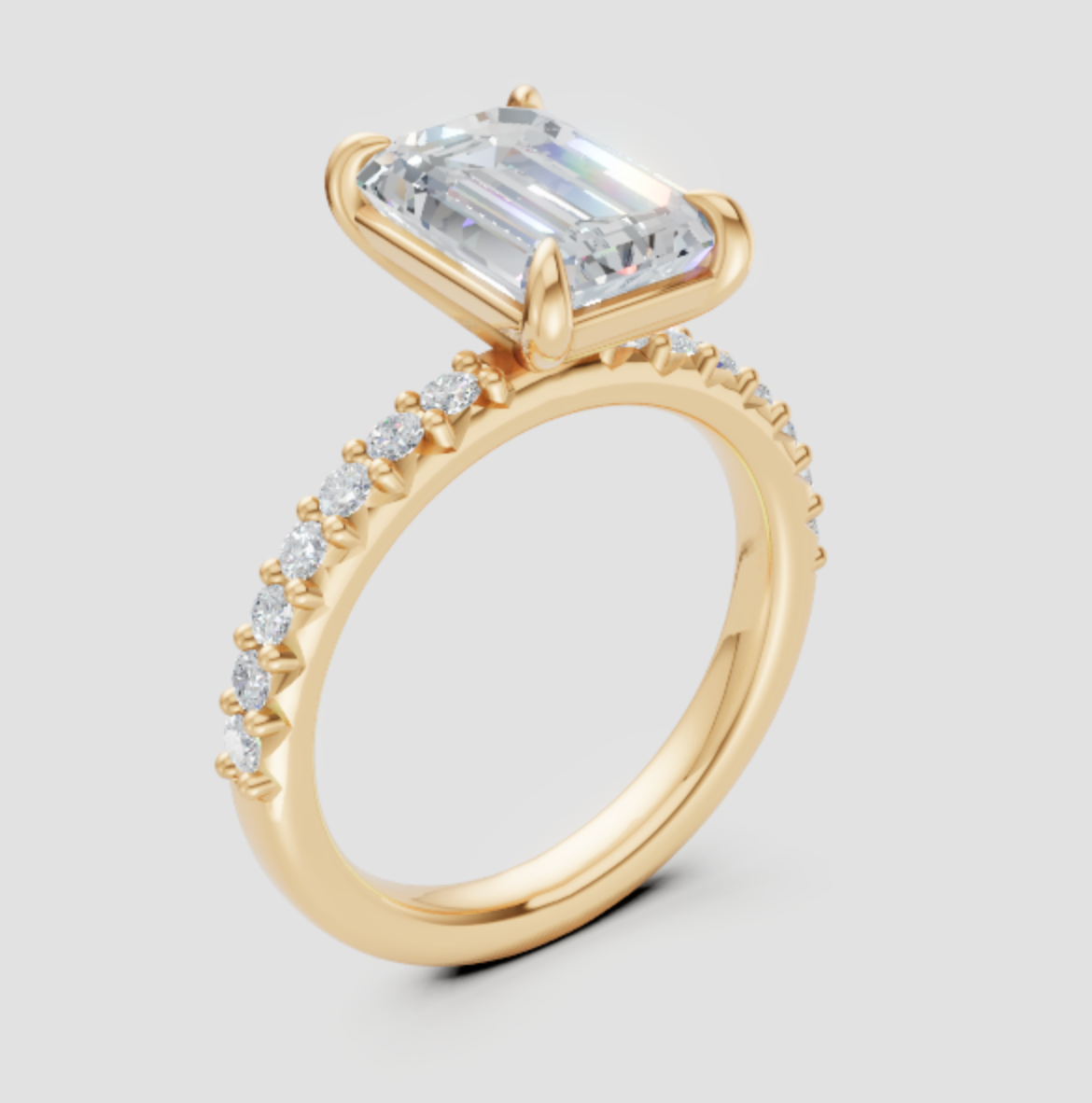 Elegant emerald cut lab-grown diamond engagement ring in yellow gold with pavé band