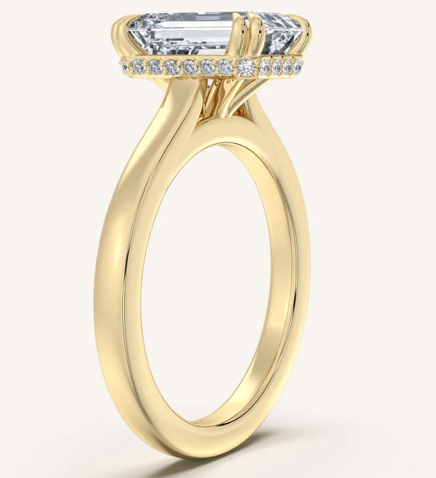 Elegant emerald cut lab-grown diamond engagement ring in yellow gold with halo accents