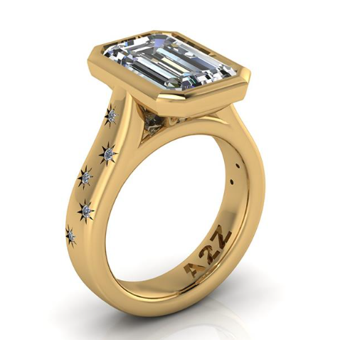 Elegant emerald-cut lab-grown diamond ring with starburst accents on gold band