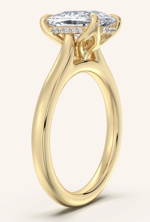 Gold ring with a diamond on a white background