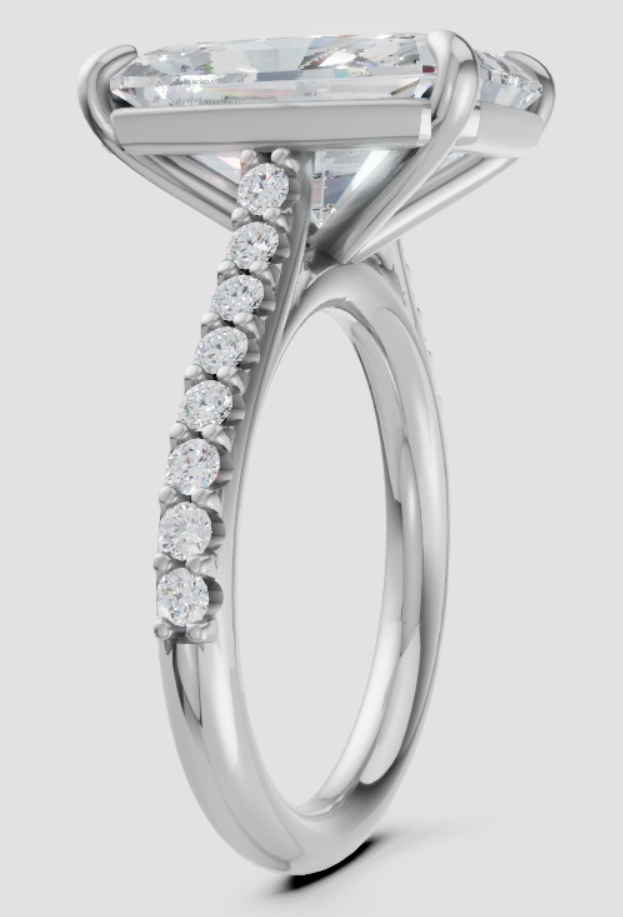 Silver ring with a large diamond and smaller diamonds on the band against a white background