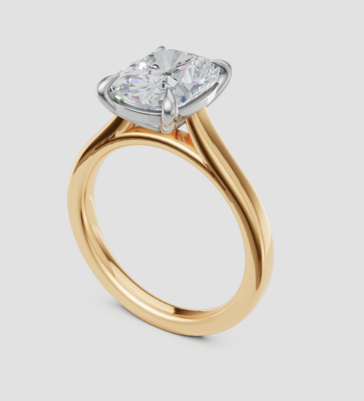 A yellow gold solitaire engagement ring with a cushion-cut diamond, set in a silver-colored halo, shown on a light gray background.