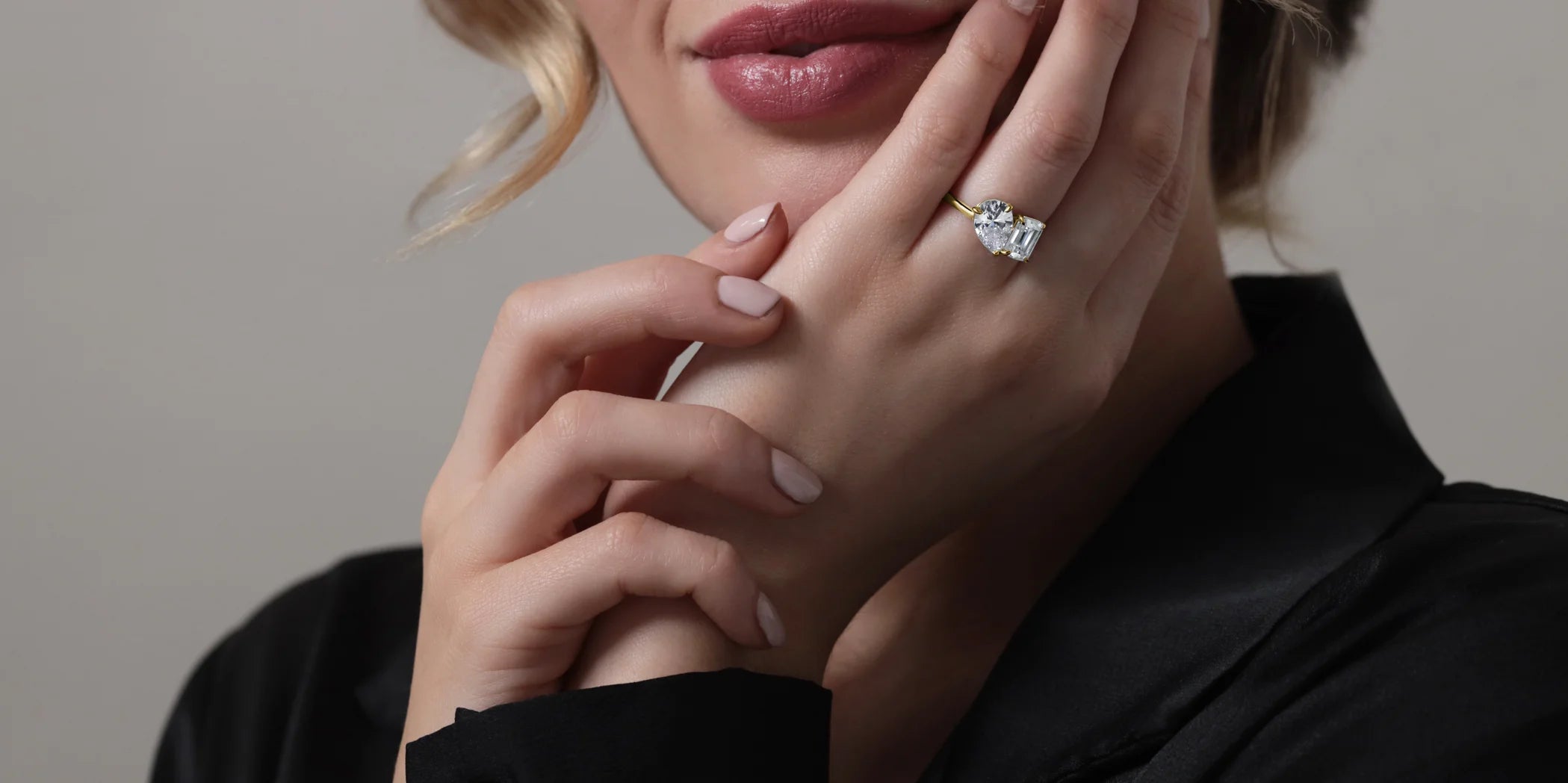 Close-up of a hand wearing a two-stone lab grown diamond engagement ring.